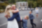Brother and nephews embrace bride during a wedding at Careys Bay