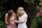 The bride's best friend admires her new wedding ring during her garden wedding in Dunedin