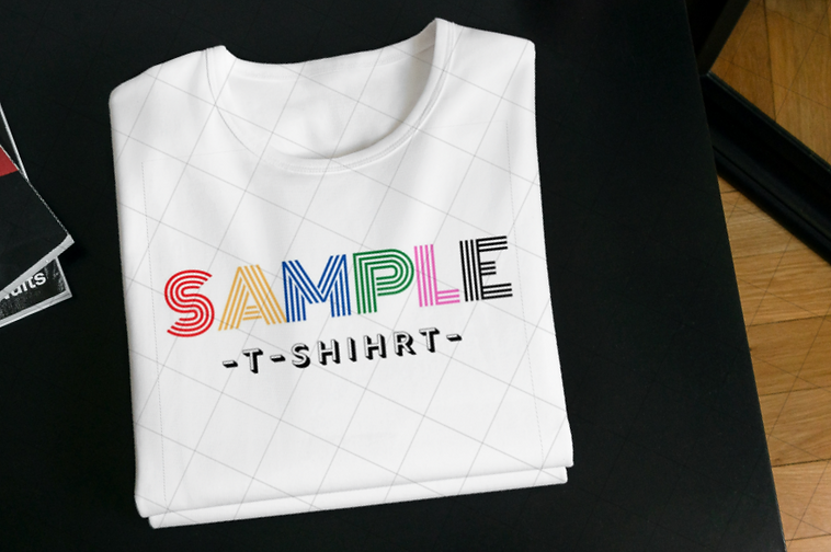 Folded T-shirts on the table_Neon Rainbow Retro Birthday Year Vintage T-Shirt_edited.png
