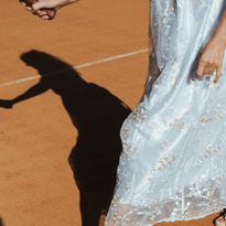girl playing tennis in a dress and heels