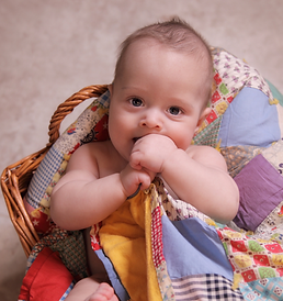 Newborn baby wrapped in quilt