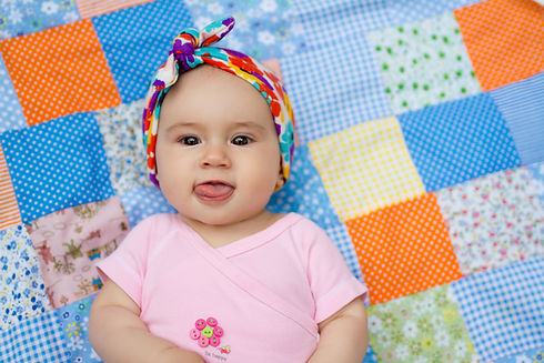 adorable-infant-smiling-on-a-patchwork-blanket-2026-03-13-04-13-33-utc.jpg
