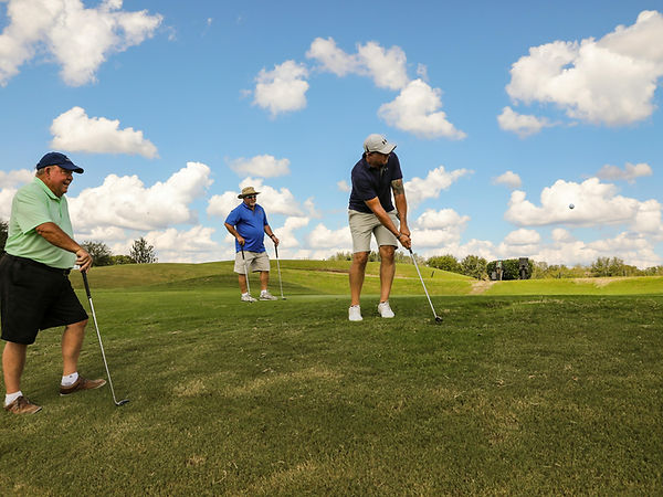 man chipping a golf ball