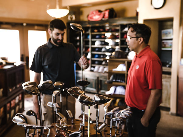 two men talking about golf in golf store