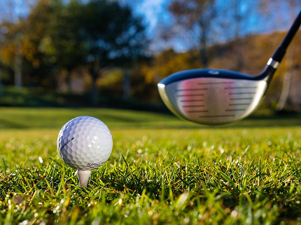 golf driver and ball on tee