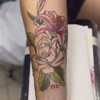 Tattoo of a magnolia and a stargazer lily in full color