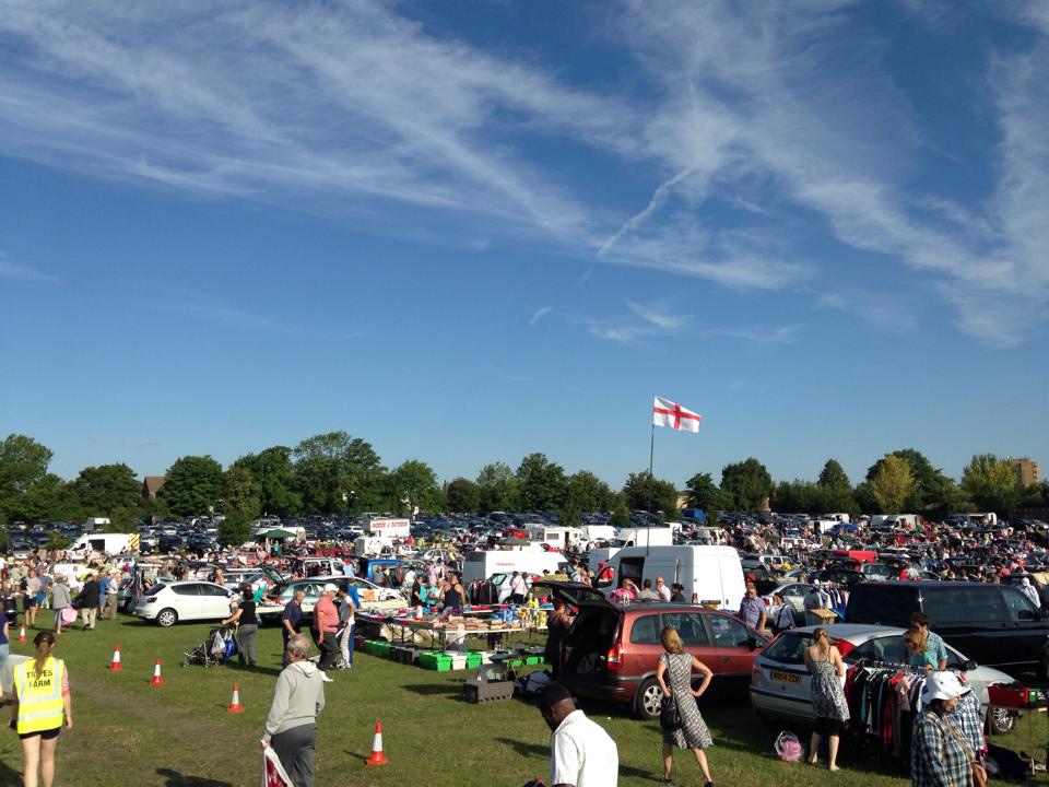 Cars, stalls and shoppers spread across a field at Tripes Farm