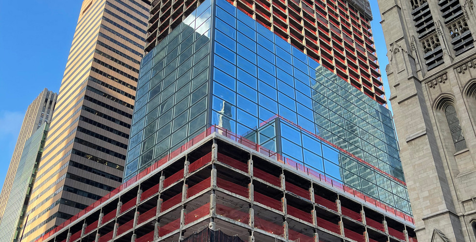 In the tower, the previous aluminum facade at the top, the exposed steel structure in the middle, the new glass elements at the bottom, and the exposed podium at the very bottom.
