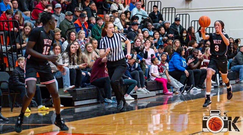 Kyla Dinkel running on a basketball court