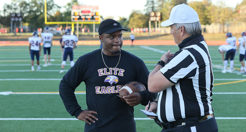 Coach and referee talking to each other.