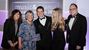 The GLOP team on stage receiving an award