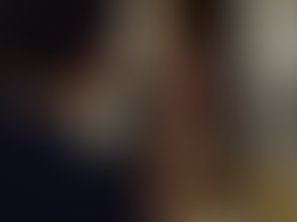 Two young people holding a trumpet together