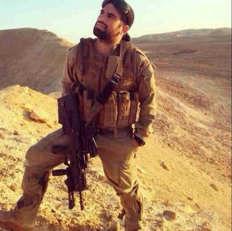 Oleh Matan Bouganim in the desert wearing an IDF combat uniform