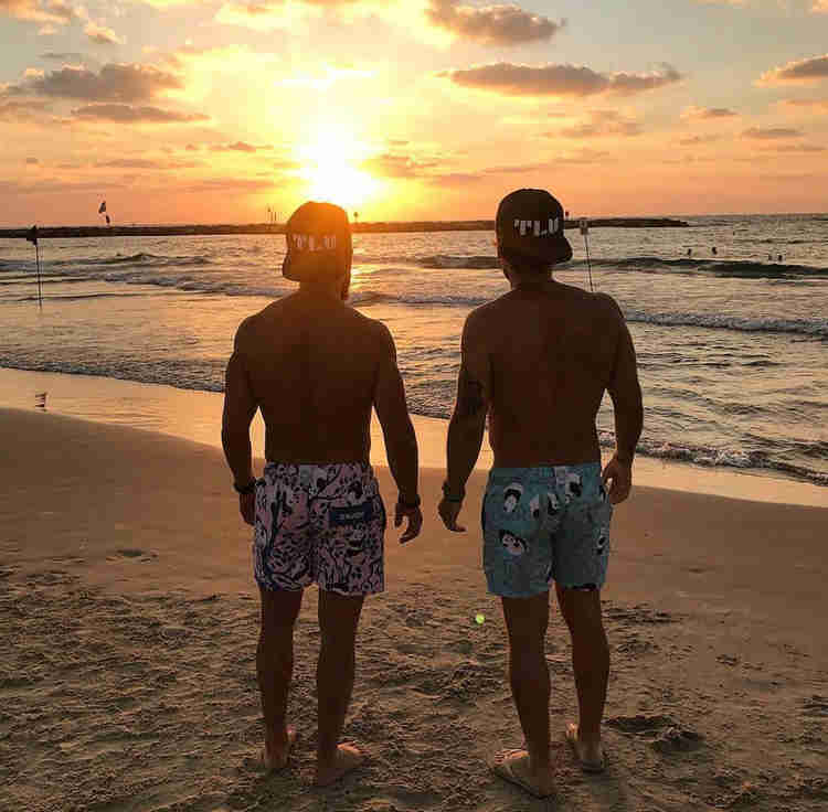 Oleh Johnny Denver Levine and a friend watching the sunset on the beach in Tel Aviv