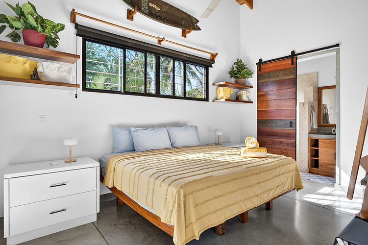 Bright double bedroom at Ten Toes Surf House in Nosara