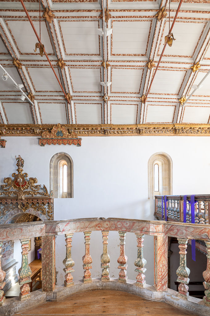 Baroque tribune with turned balusters and painted coffered ceiling in the church of Vila Boa do Bispo