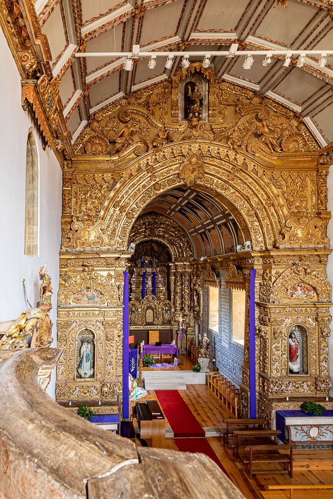 Gilded triumphal arch and tiled chancel of the church of Vila Boa do Bispo seen from the tribune