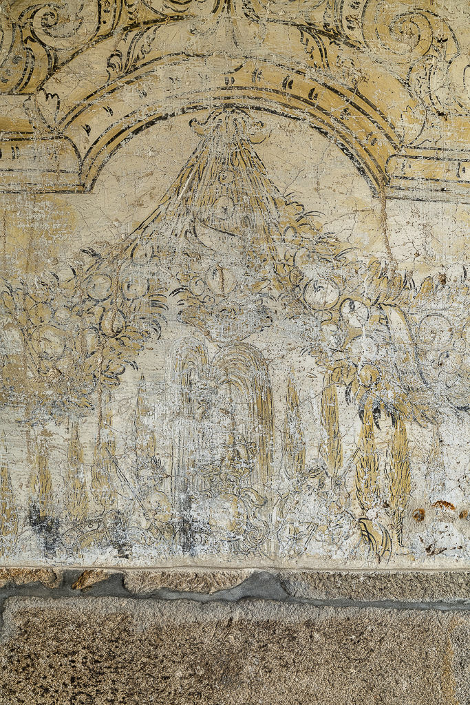 Fragment of mural painting with scrolls and foliage on a cloister wall, Vila Boa do Bispo