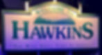A sign reading Welcome to Hawkins "The Best Small Town in America"