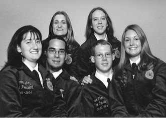 Six smiling NC FFA state officers 2000s in uniform jackets.