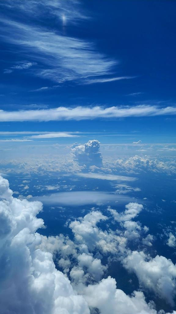 Fluffy white clouds against bright blue sky