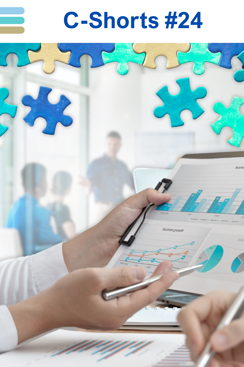 Hands hold a clipboard with graphs. Puzzles pieces overlay a blurred meeting room with three people. Blue and beige colors present.