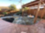 Backyard patio with decorative concrete, a wood pergola and a round fire pit