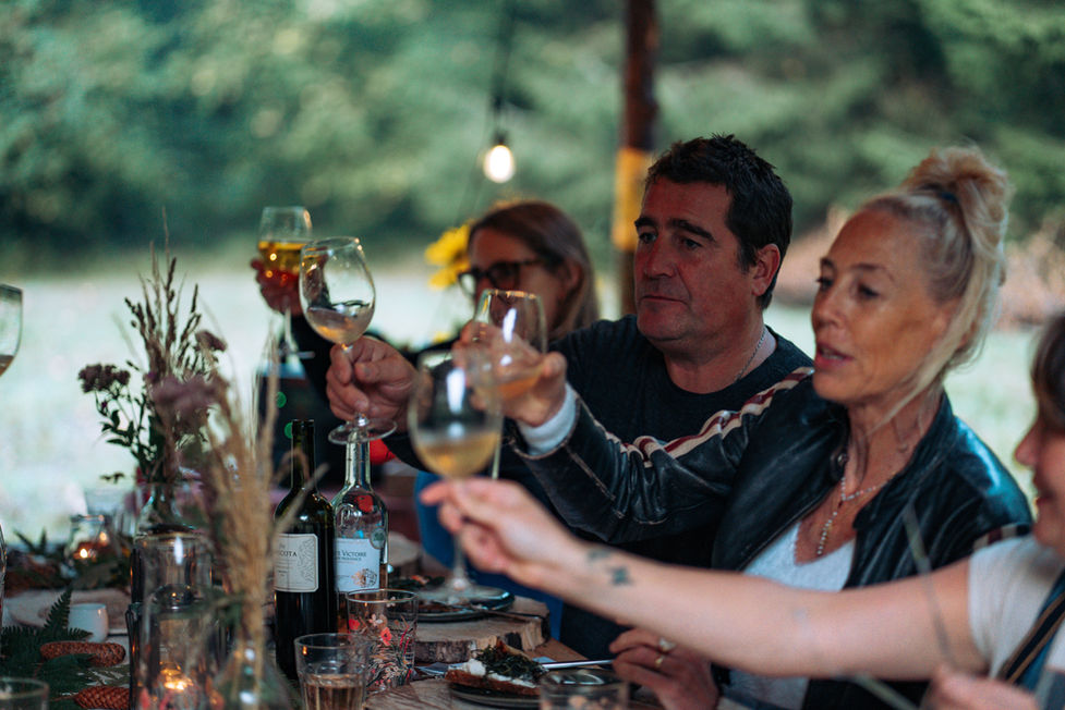 Diners toasting at The Woodland Table, Glastonbury.