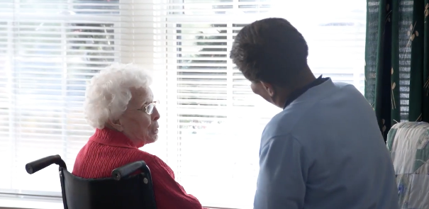 Patient with heart condition speaking with hospice aide.