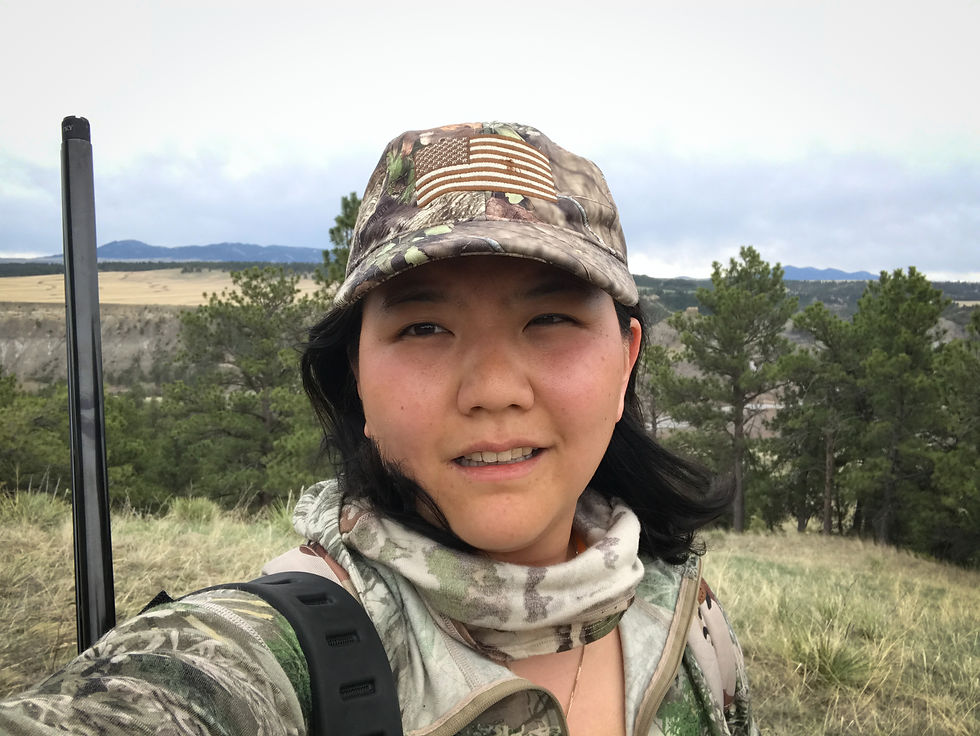 Helen, with a shotgun slung over her shoulder...on a turkey hunt.