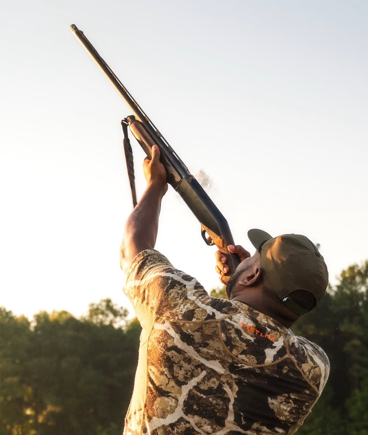 Joe, with shotgun aimed high on a dove hunt.