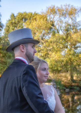 Bride and groom gaze in to the distance at Layer Marney Tower