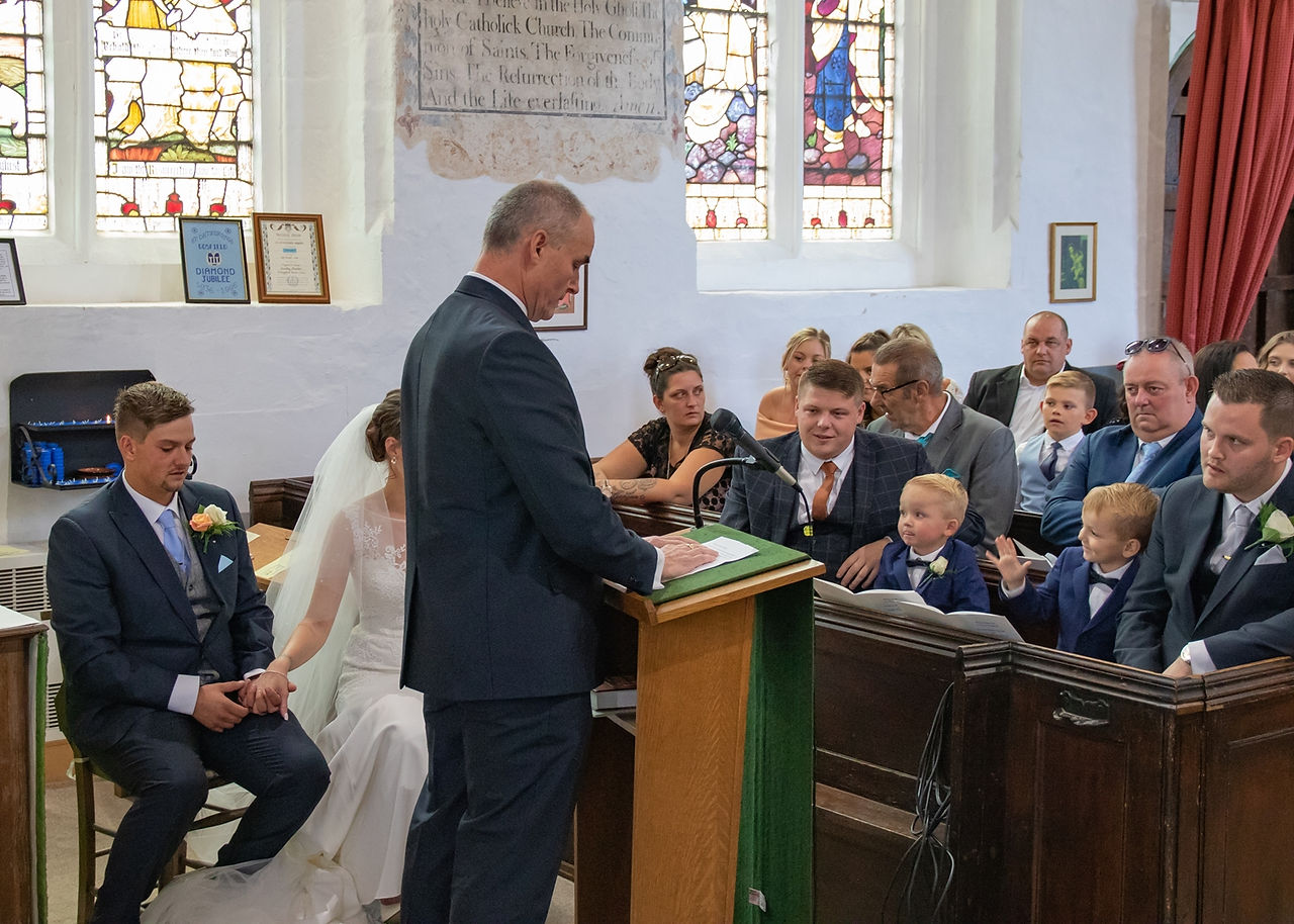 Father of the bride giving one of the readings during the church wedding ceremony