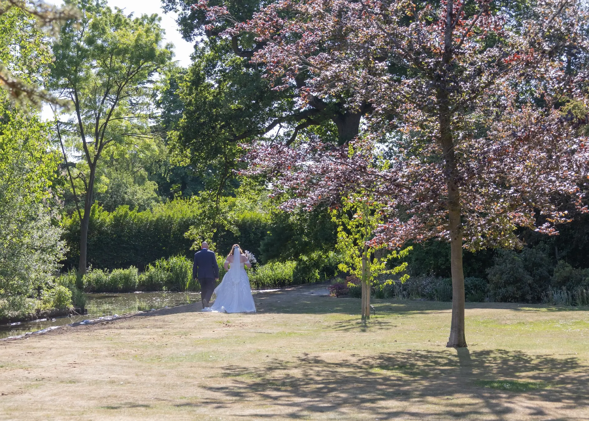 Wedding couple walking in the grounds of Langtons House