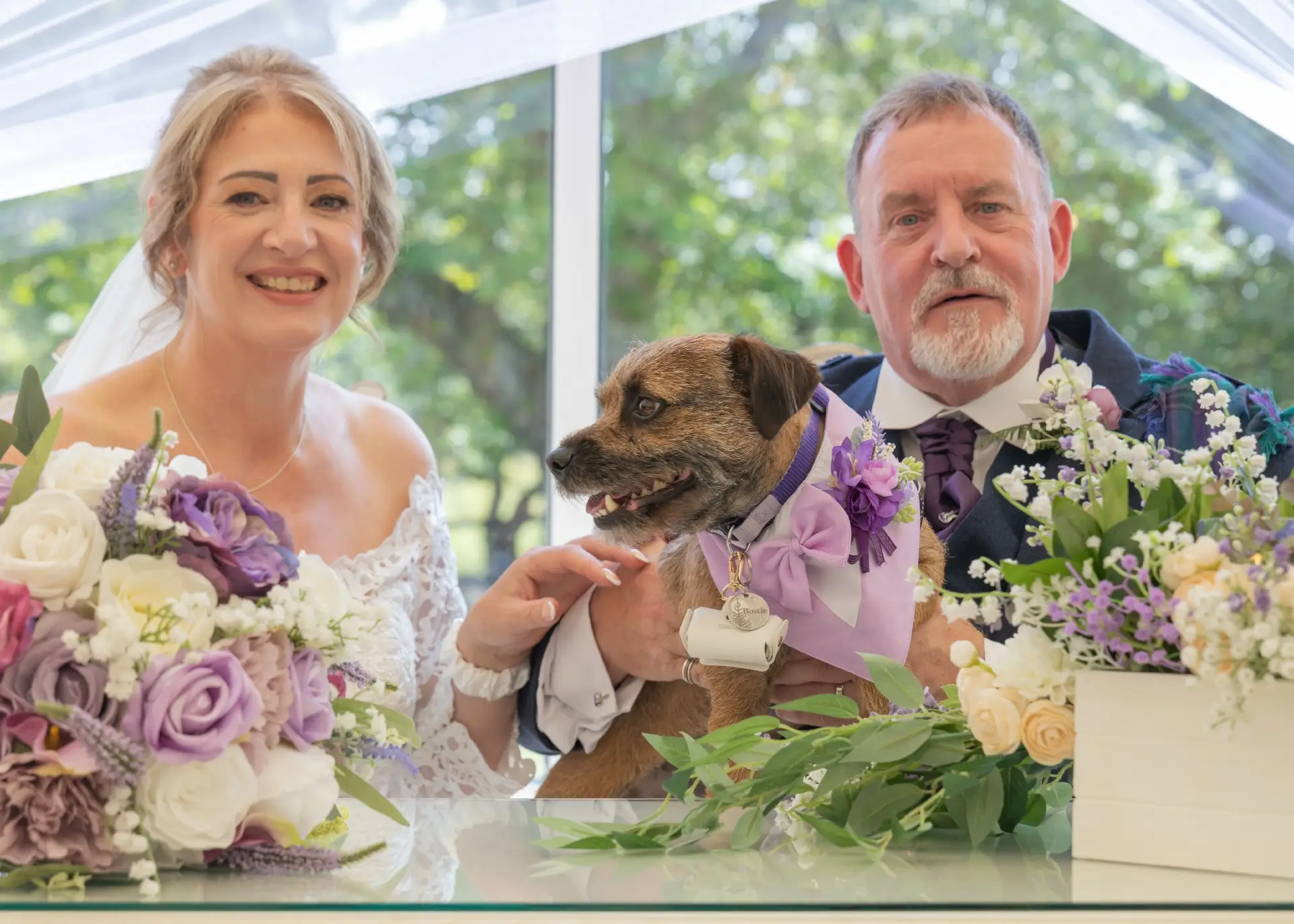 Bride and groom with their ring bearer at The Fennes