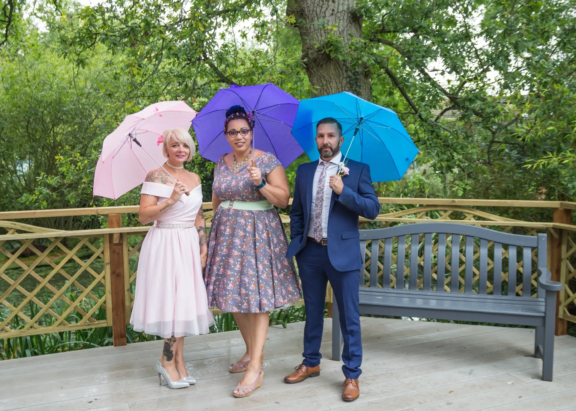 Couple with their celebrant in the rain at The Ivy Hill Hotel