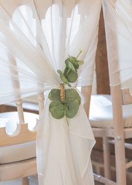 White chair drape with green foliage decoration