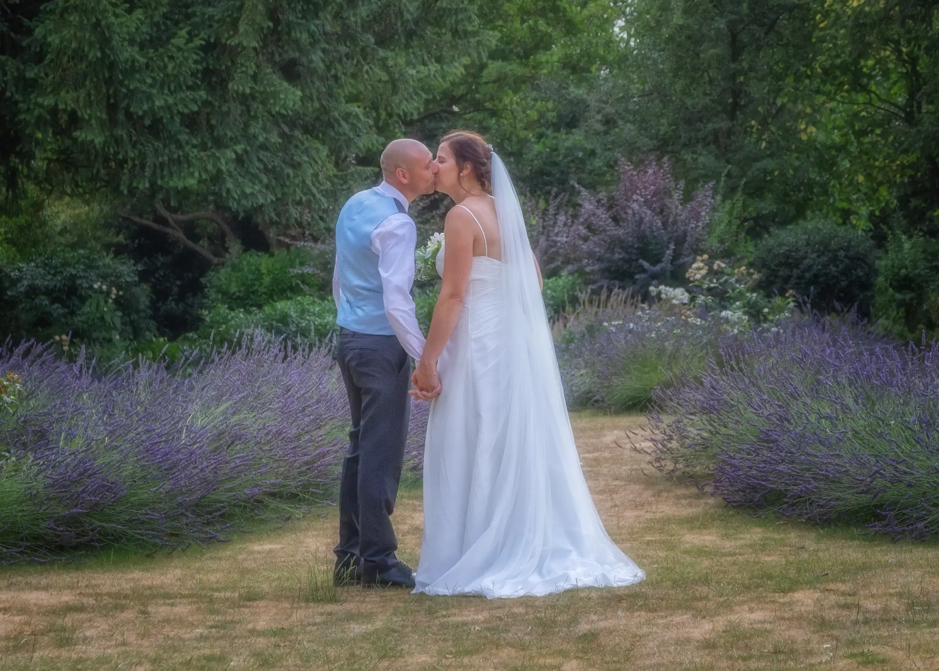 Bride and groom kissing in the grounds at Langtons House
