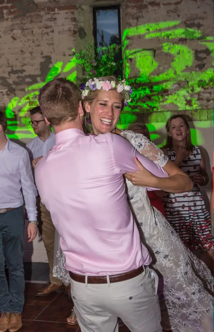 Groom swings his bride round during their first dance at Great Lodge, Bardfield