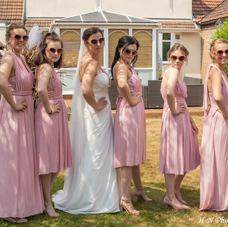 Bridal party in soft pink relax and have fun before leaving for the ceremony
