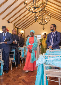 Bridesmaid enters the ceremony room at Crondon Park in front of the bride