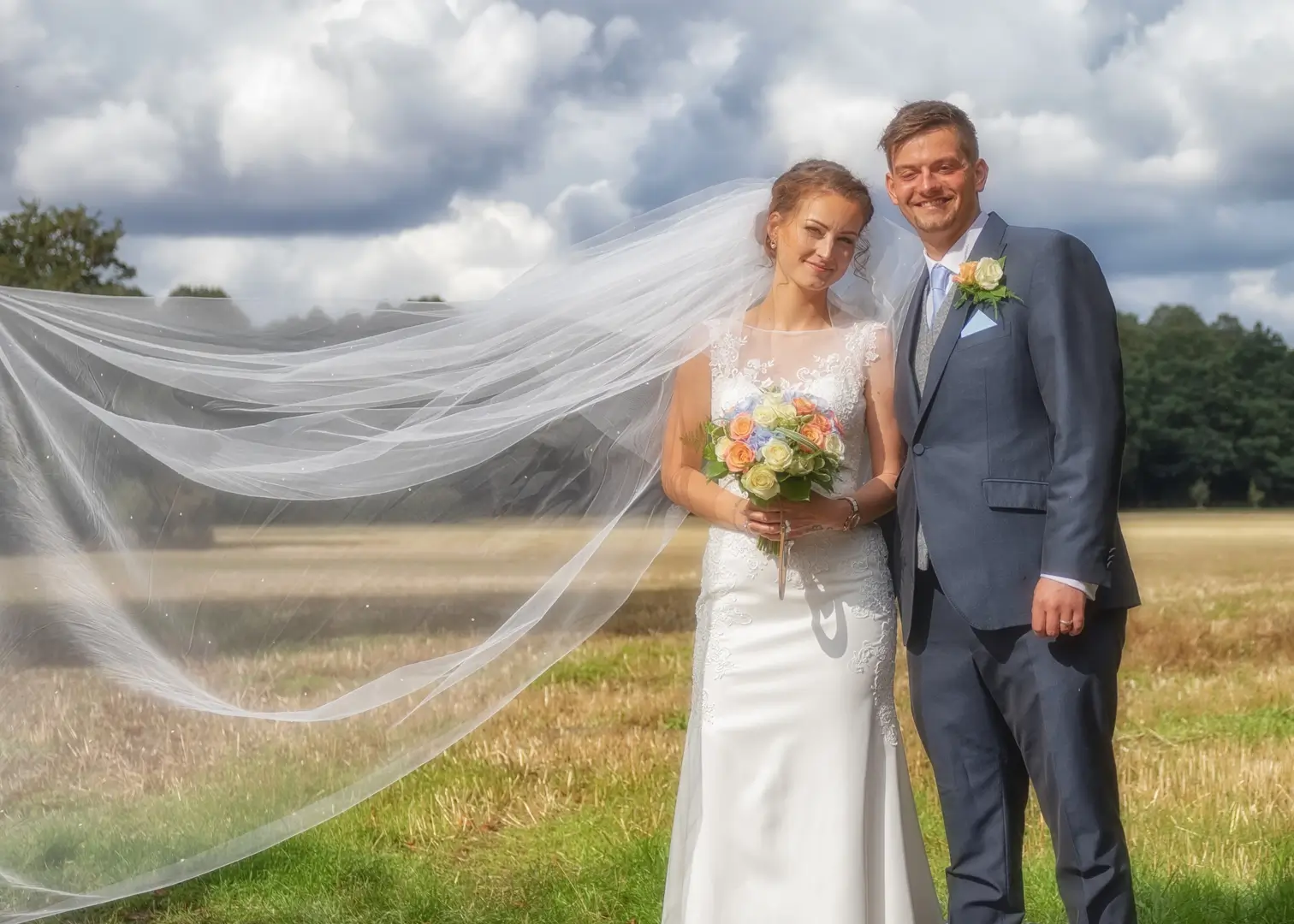 Dramatic clouds and sunshine with a breeze for Gosfield wedding