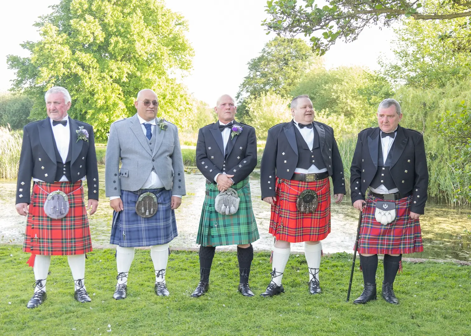 Groom with best man and family all in kilts at Prested Hall