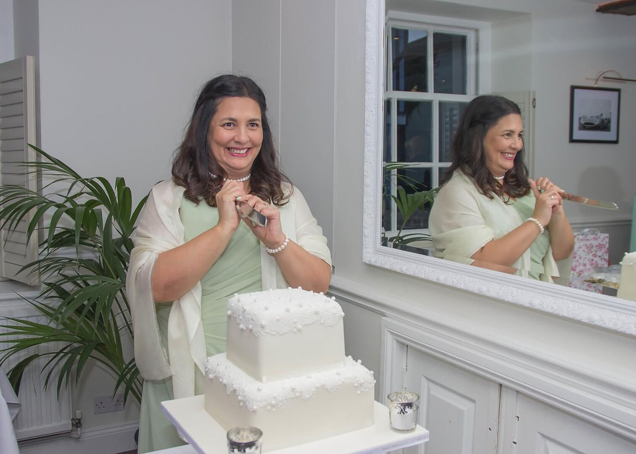 Bride mischievously brandishes the knife ready to cut the wedding cake