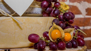 Kumquats and red grapes decorating a cheese wedding cake tower