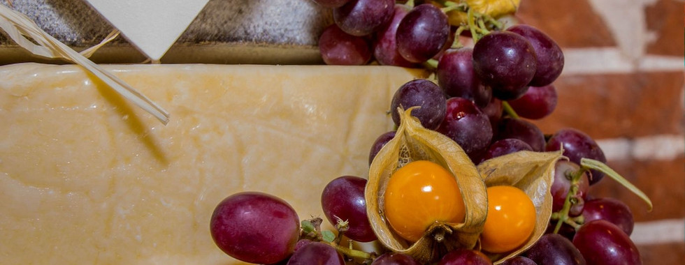 Grape and cumquat decorations on rustic cheese wedding cake