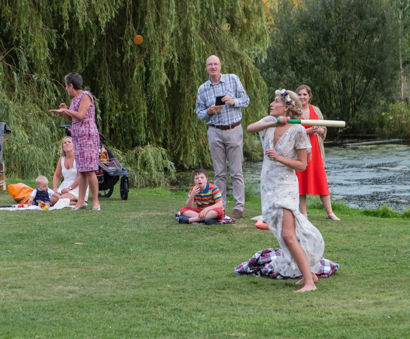 Bride playing rounders at her Great Lodge, Bardfield wedding