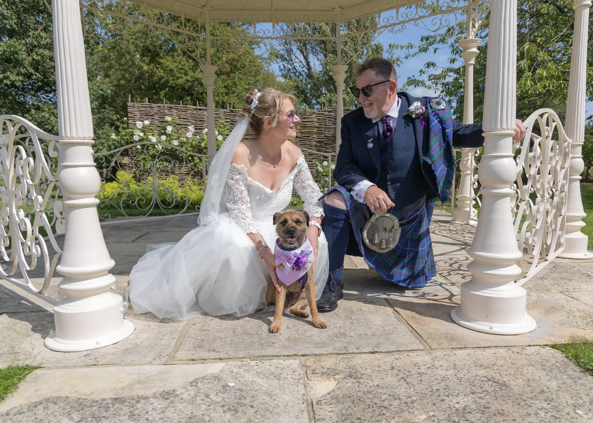 Wedding couple with their dog under the gazebo at The Fennes