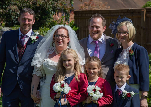 Wedding group photo with bridesmaids and page boy in navy and burgundy at The Bull, halstead in Essex