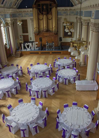 Aeriel view of tables decorated in purple and white ready for a wedding reception at Colchester Town Hall